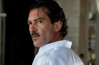 Headshot of Antonio Banderas with mustache looking sideways