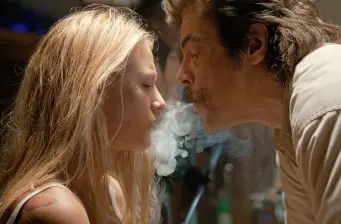 man and woman blowing smoke towards each other in close profile