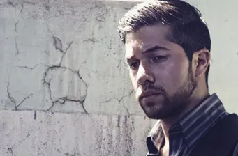 Walter Perez close-up headshot with cracked wall background