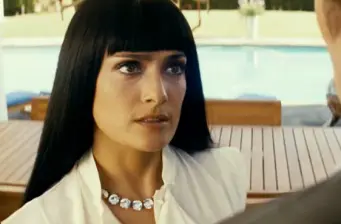 woman with long black hair in white blouse by pool outdoors
