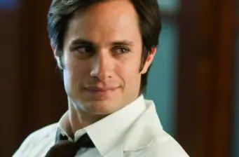 Unidentified man in white shirt looking sideways with slight smile