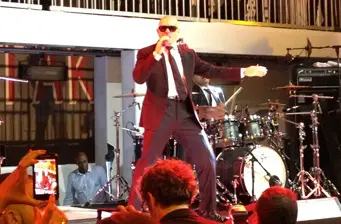 Man in suit sings on stage at Men in Black 3 after party