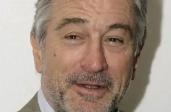 Close-up headshot of Robert De Niro with slight smile