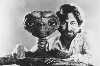 Steven Spielberg poses next to E.T. puppet in black and white photo