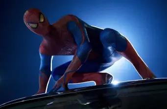Spider-Man crouching on vehicle roof in dark blue lighting
