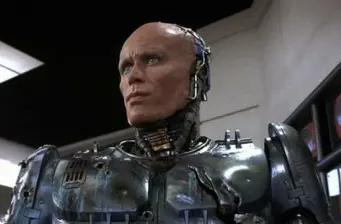 Robocop wearing battered, damaged armor in movie scene