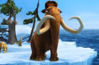 Manny the mammoth standing on ice with ocean and trees behind