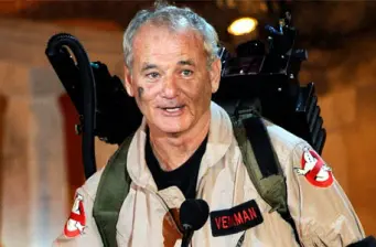 Bill Murray in Ghostbusters uniform with proton pack, smiling