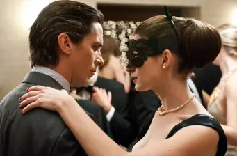 Man and woman dancing at masked ball in The Dark Knight Rises