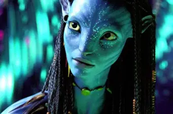 Close-up of Neytiri, blue Avatar character with braids, looking sideways