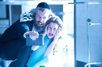 Man in yarmulke grabbing terrified woman inside bathroom