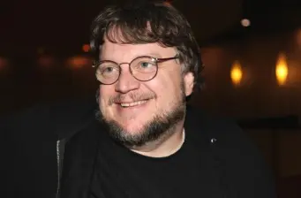 Mexican filmmaker Guillermo del Toro smiling wearing glasses and black shirt