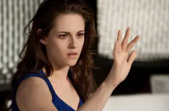 Kristen Stewart raises hand, focused, scene from Twilight Saga Breaking Dawn