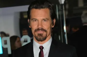 Josh Brolin wearing suit and tie, looking at camera