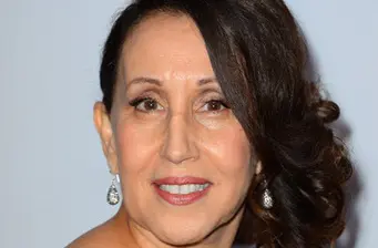 Headshot of Latina actress Gloria Laino smiling at camera