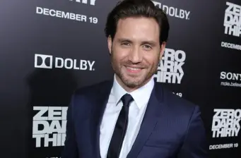 Edgar Ramirez in navy suit smiling on Zero Dark Thirty red carpet