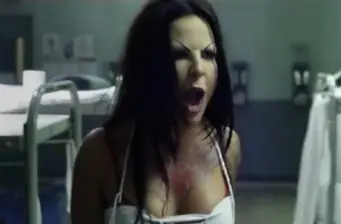 Kate del Castillo yelling with bloody chest in tense movie scene