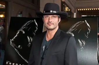 Robert Rodriguez in black hat at horror film premiere