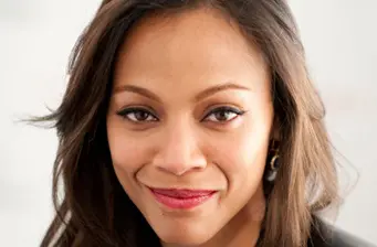 Zoe Saldana close-up headshot smiling at camera