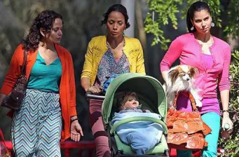 A scene depicting three women with a baby stroller and dog from Devious Maids.
three women walk with baby stroller and small dog outdoors