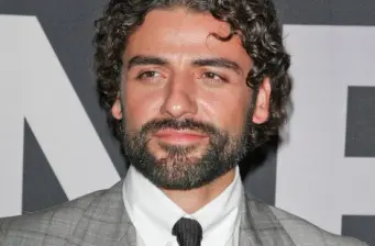 Close-up headshot of Oscar Isaac with beard at event