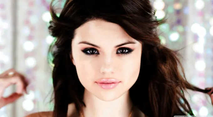 Close-up headshot of Selena Gomez with dramatic eye makeup