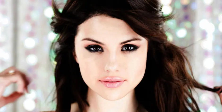 Close-up headshot of Selena Gomez with dramatic eye makeup