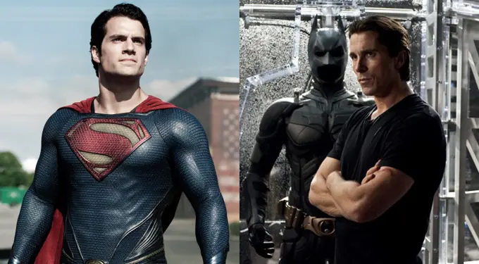Superman in costume outdoors beside man with Batman suit indoors