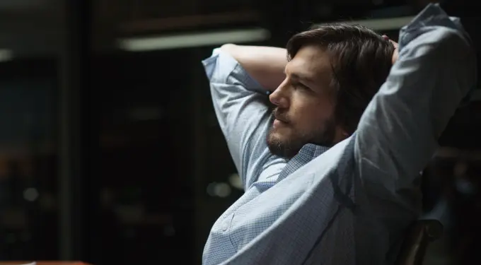 Ashton Kutcher leans back in chair, deep in thought