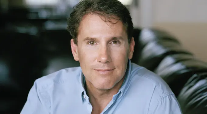 Nicholas Sparks close-up headshot looking at camera in blue shirt