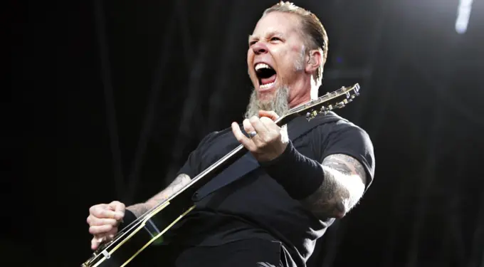 James Hetfield plays guitar yelling during Metallica live show