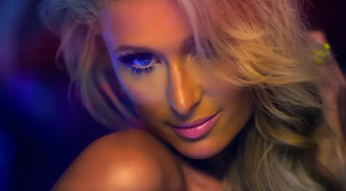Close-up headshot of Paris Hilton with blonde hair and bright makeup