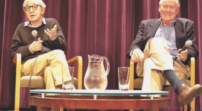 Woody Allen and David Picker seated, speaking with microphones at event
