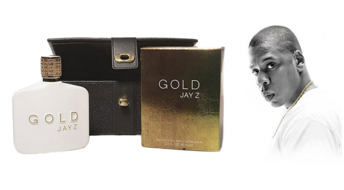 Jay-Z Gold fragrance bottle, box, and case next to black-and-white portrait of Jay-Z