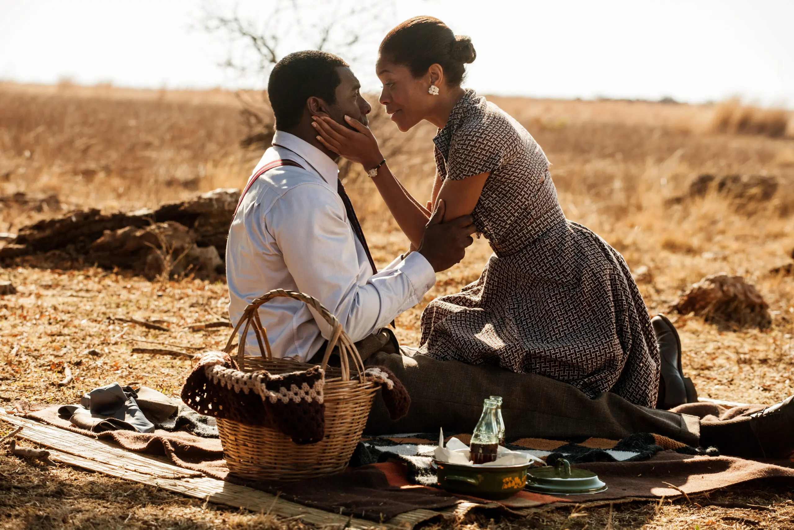Man and woman share tender moment at outdoor picnic