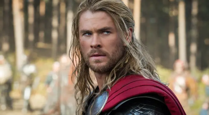 Chris Hemsworth as Thor in armor and red cape looking sideways