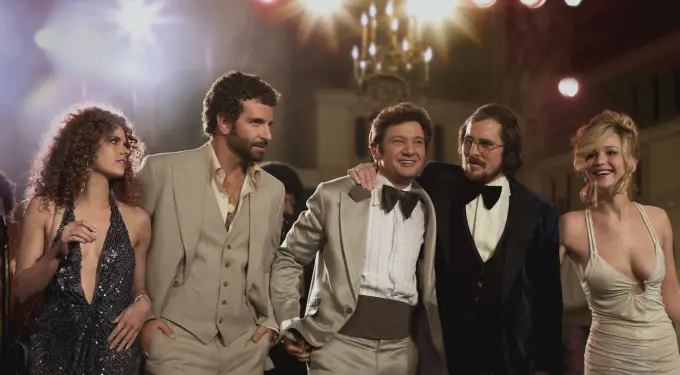 American Hustle cast in 1970s outfits at party scene