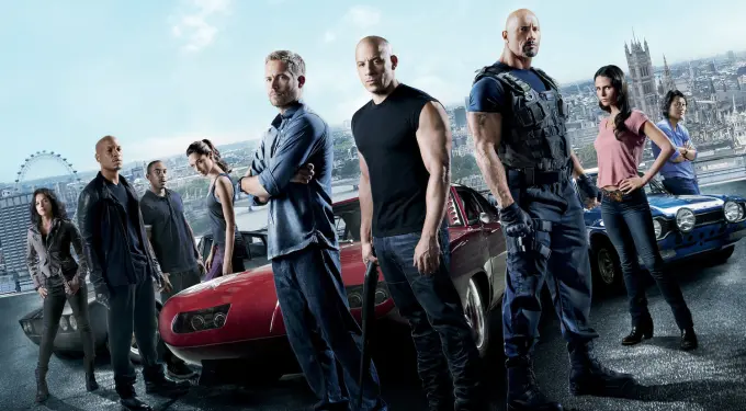 Promotional group image of Fast & Furious 6 cast with cars in London background
Actors from Fast & Furious 6 stand with cars and London skyline