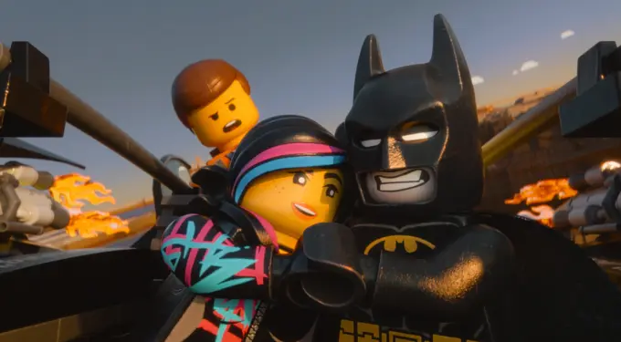 Batman and two LEGO characters in vehicle firing guns