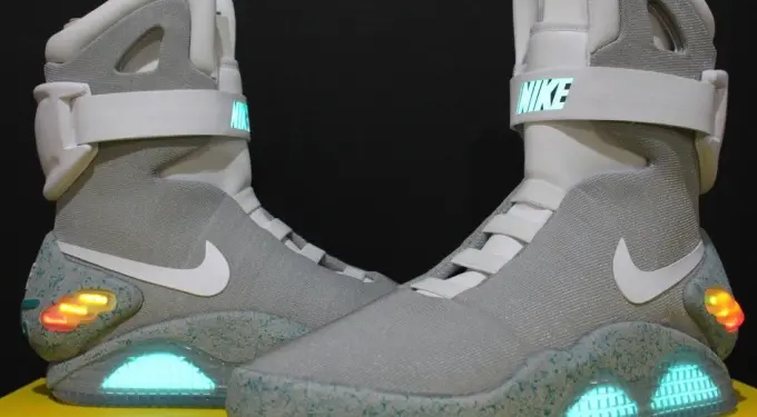 Nike Air Mag shoes with glowing blue soles and white straps