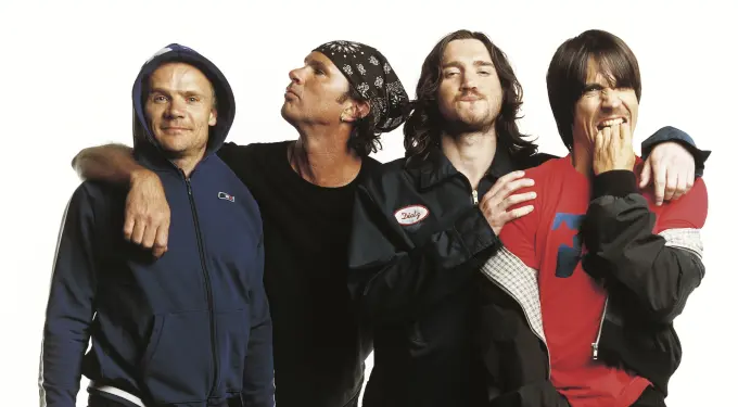 Red Hot Chili Peppers band members posing casually for a photo