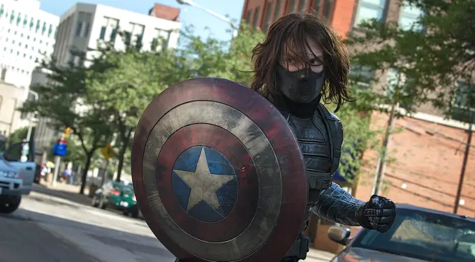 Scene from ‘Captain America: The Winter Soldier’ showing the masked soldier wielding the shield.
The Winter Soldier holding Captain America’s shield on city street
