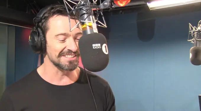 Man smiles while speaking into BBC Radio 1 microphone in studio