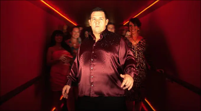 Nick Frost walking in red hallway scene from Cuban Fury
