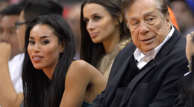 Donald Sterling and V. Stiviano sitting together at event