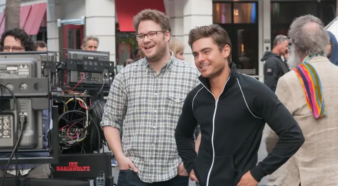 Two men smiling on set with film equipment in background