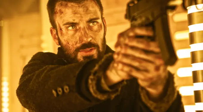 Chris Evans aiming gun, face bruised, tense moment from Snowpiercer