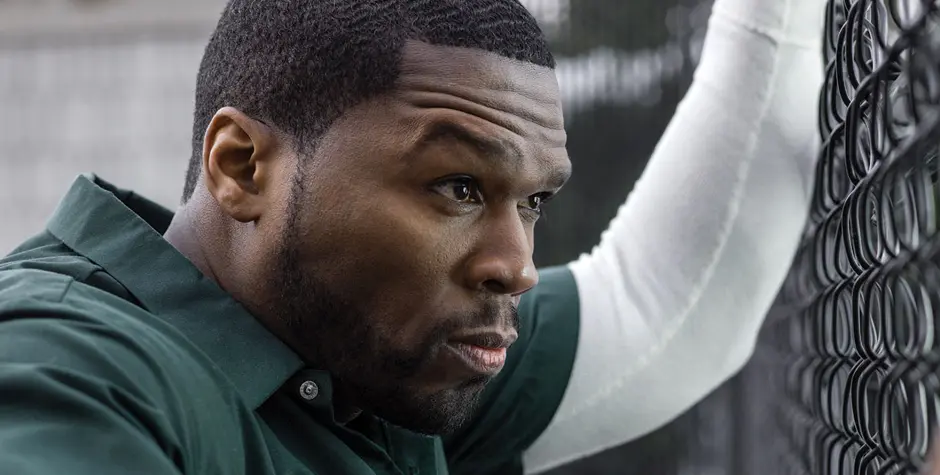 50 Cent in STARZ’s ‘Power’
50 Cent in green shirt leans on fence, intense look
