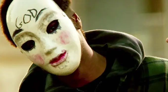 Man wearing white mask with GOD written on forehead in The Purge: Anarchy