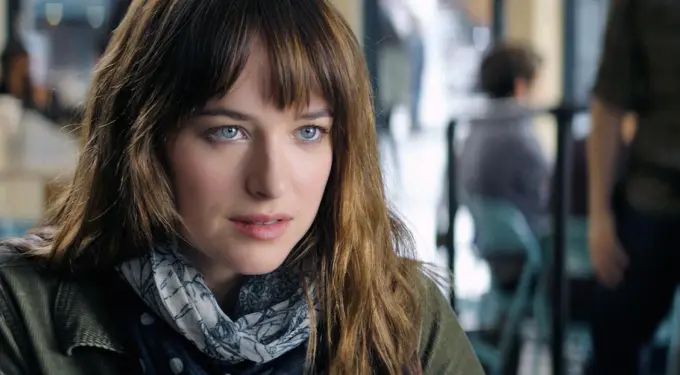 Close-up of woman with brown hair and blue eyes indoors